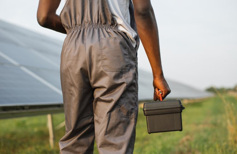 close-up-of-technician-with-tools-standing-on-solar