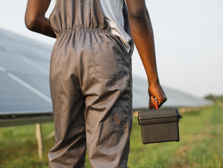 close-up-of-technician-with-tools-standing-on-solar